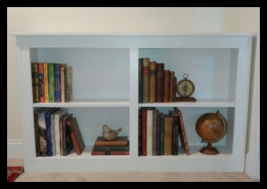 Custom double-wide white portable bookcase handcrafted with a Maple veneer core and a solid tabletop, designed for versatile home placement.