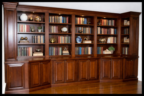 16ft cherry floor-to-ceiling library; 6 bays of open shelving with fluted moldings and custom angled corners; solid wood.