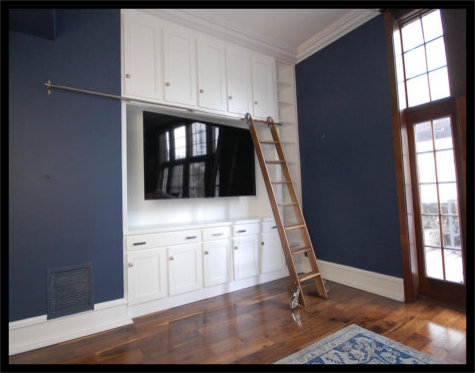 12ft high white entertainment center with mission style cabinetry, widescreen TV area, and custom rolling library ladder.