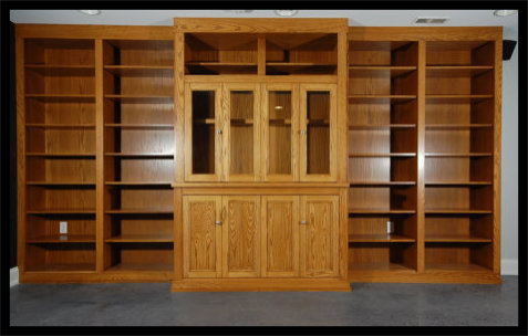 16ft Red Oak entertainment center; Mission style glass and solid doors, with floor-to-ceiling open bookcase bays.