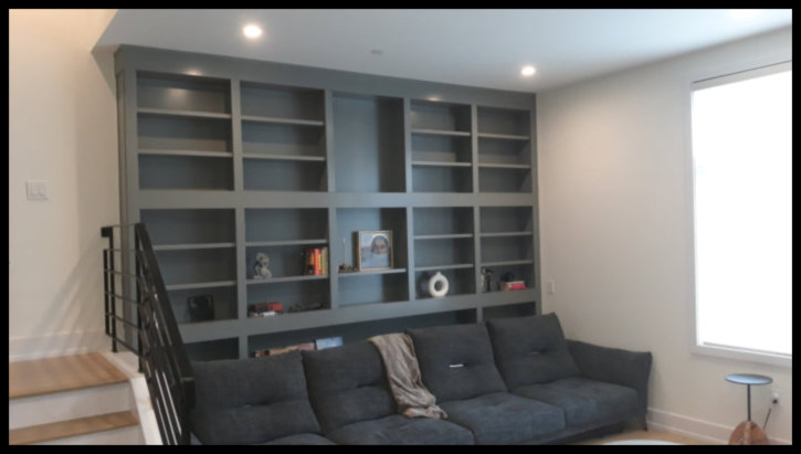 Premier example of a custom floor-to-ceiling wall-to-wall Maple library featuring light gray finish and architectural moldings.