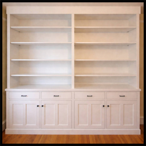 8x8 white custom cabinetry; 20-inch deep shelving for pottery and books with 4 double Mission doors and drawers.